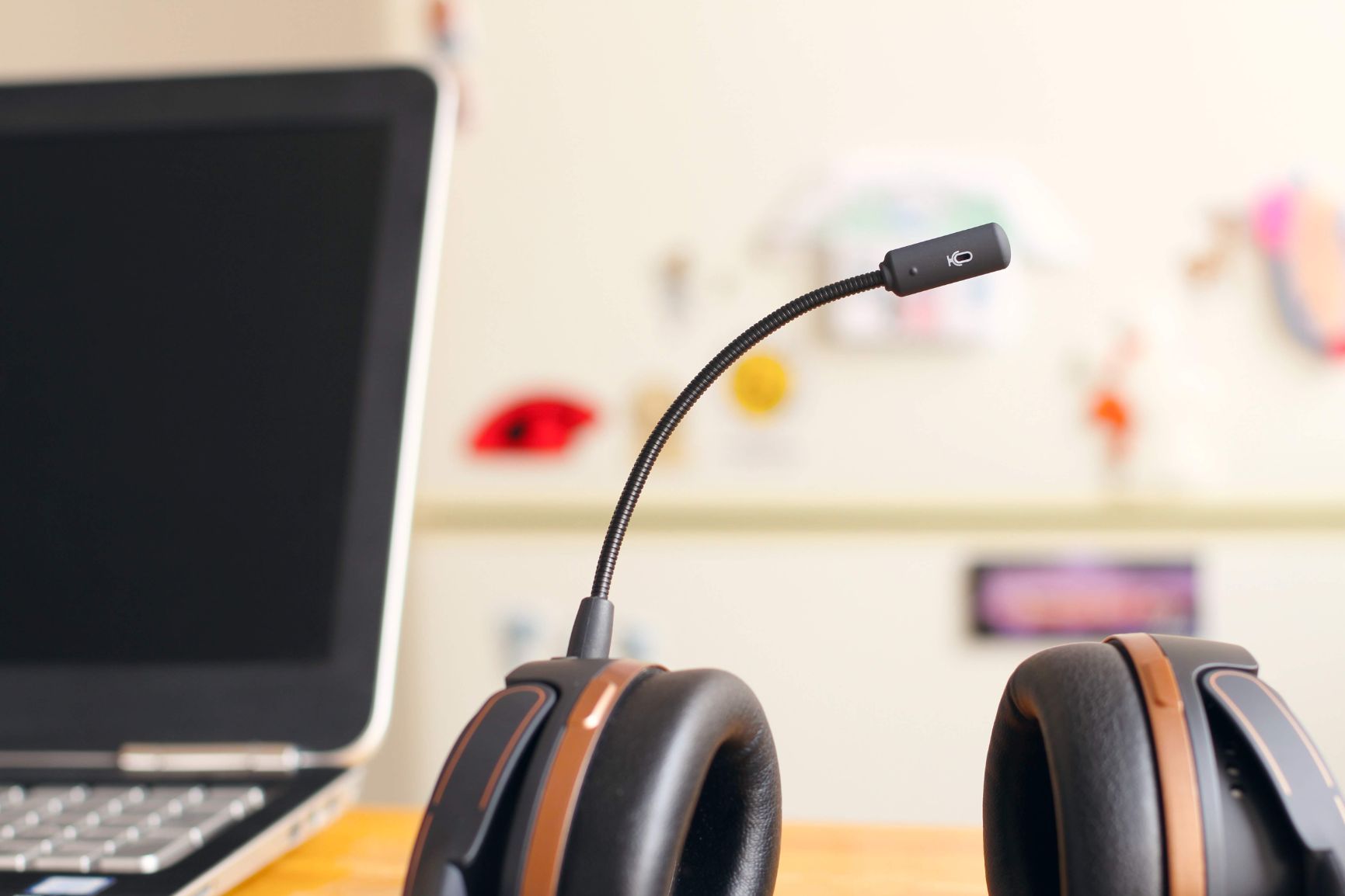 A laptop and a pair of headphones on a desk