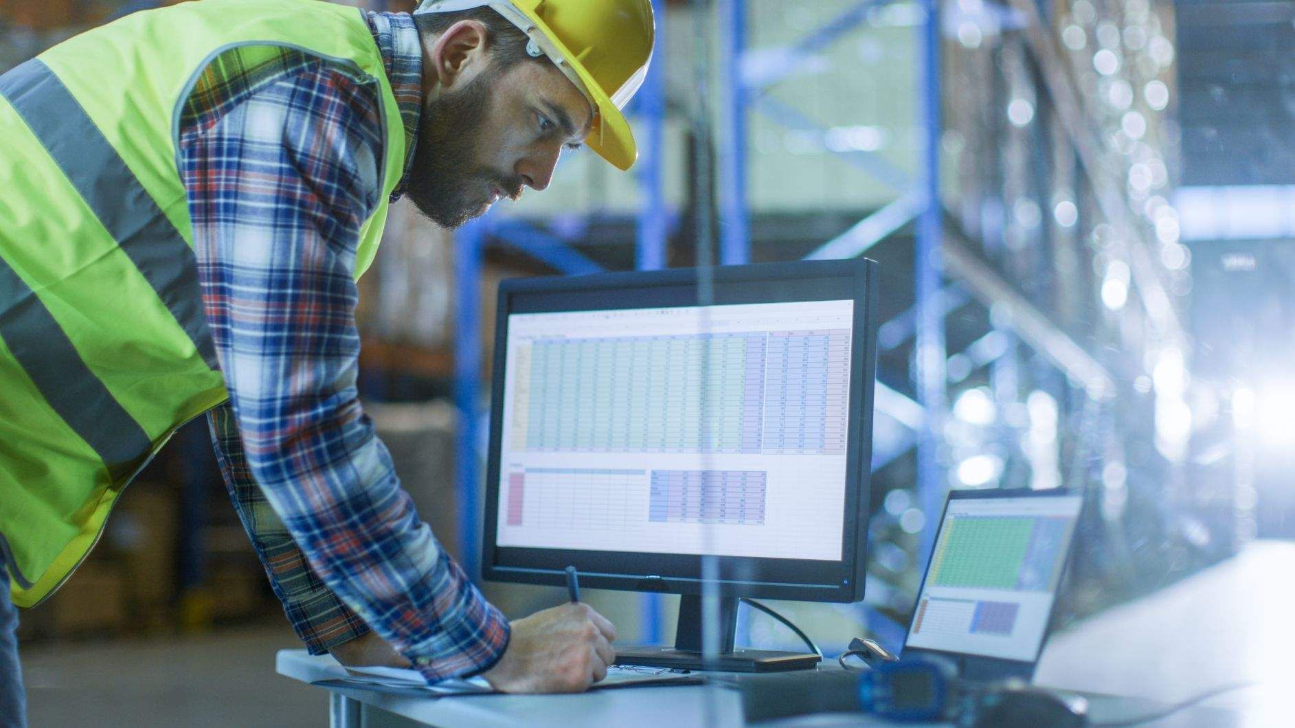 Worker looking at a computer in a warehouse
