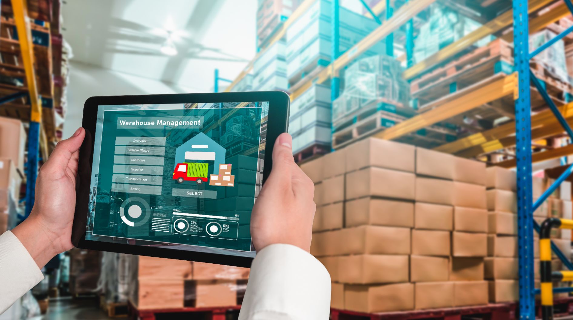 A worker holding up a tablet in a warehouse